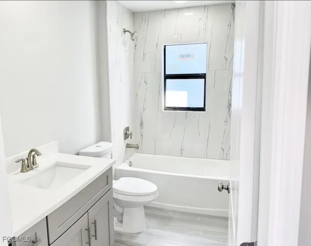 a bathroom with a toilet sink and bathtub