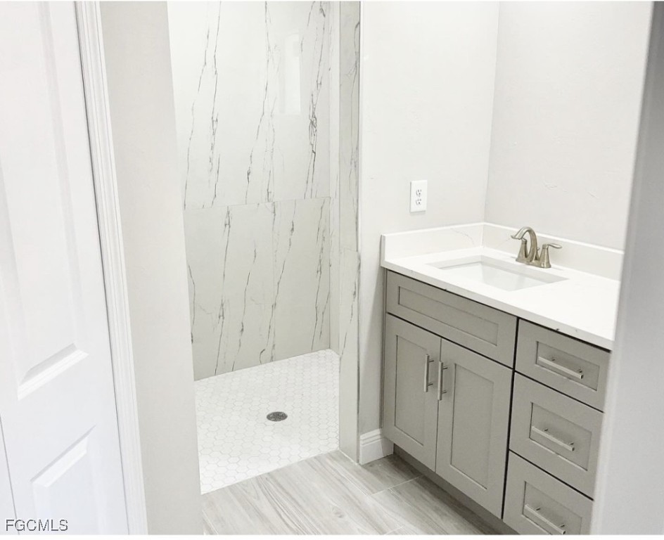 4116 2nd Street Southwest Lehigh Acres, FL 33976 - Photo 4 of 5 a bathroom with a sink and a mirror