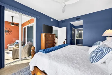 a bedroom with a bed and dresser with mirror