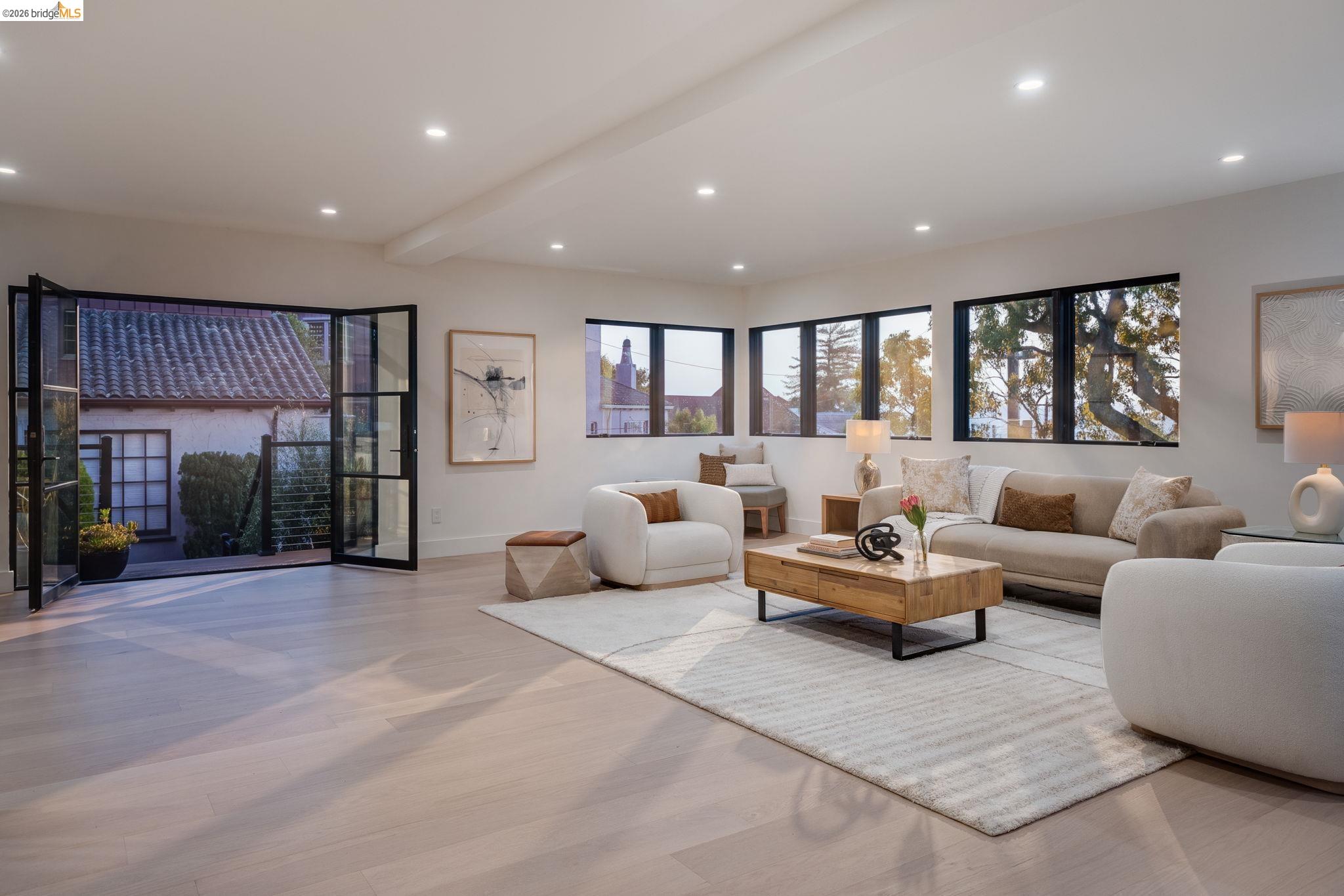 1409 Scenic Avenue Berkeley, CA 94708 - Photo 17 of 28 Spacious living area featuring light wood-finish flooring, recessed lighting, and multiple large windows with dark frames