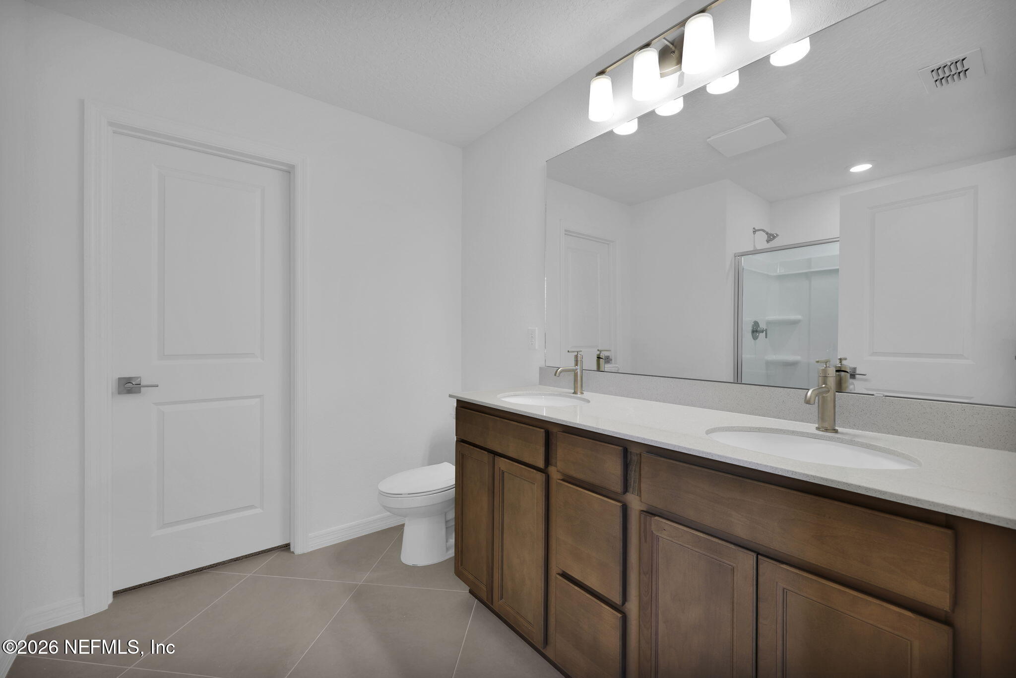 1706 Mickey Way Middleburg, FL 32068 - Photo 19 of 27 a bathroom with a double vanity sink and a toilet