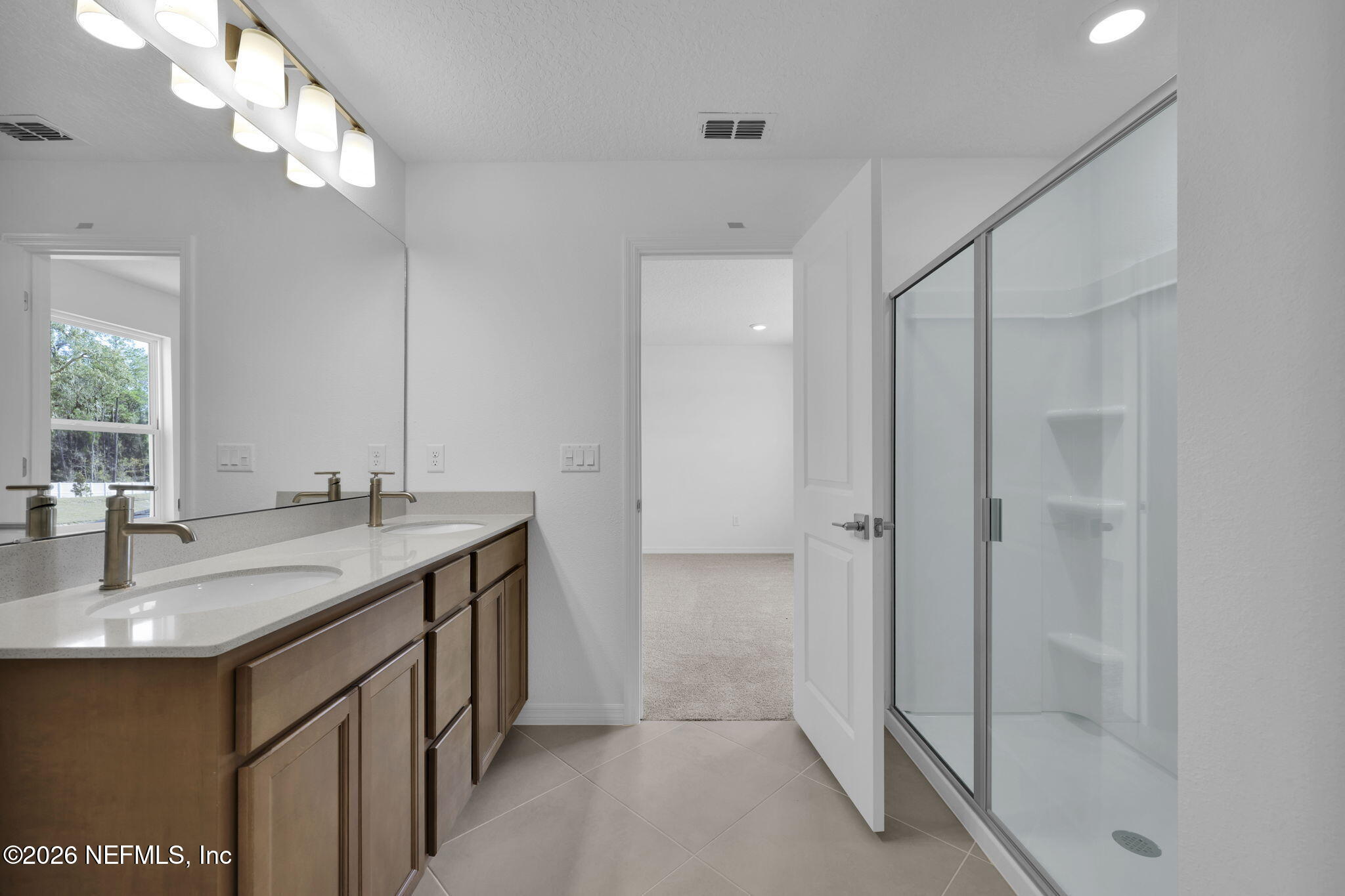 1706 Mickey Way Middleburg, FL 32068 - Photo 20 of 27 a bathroom with a granite countertop sink a mirror and shower