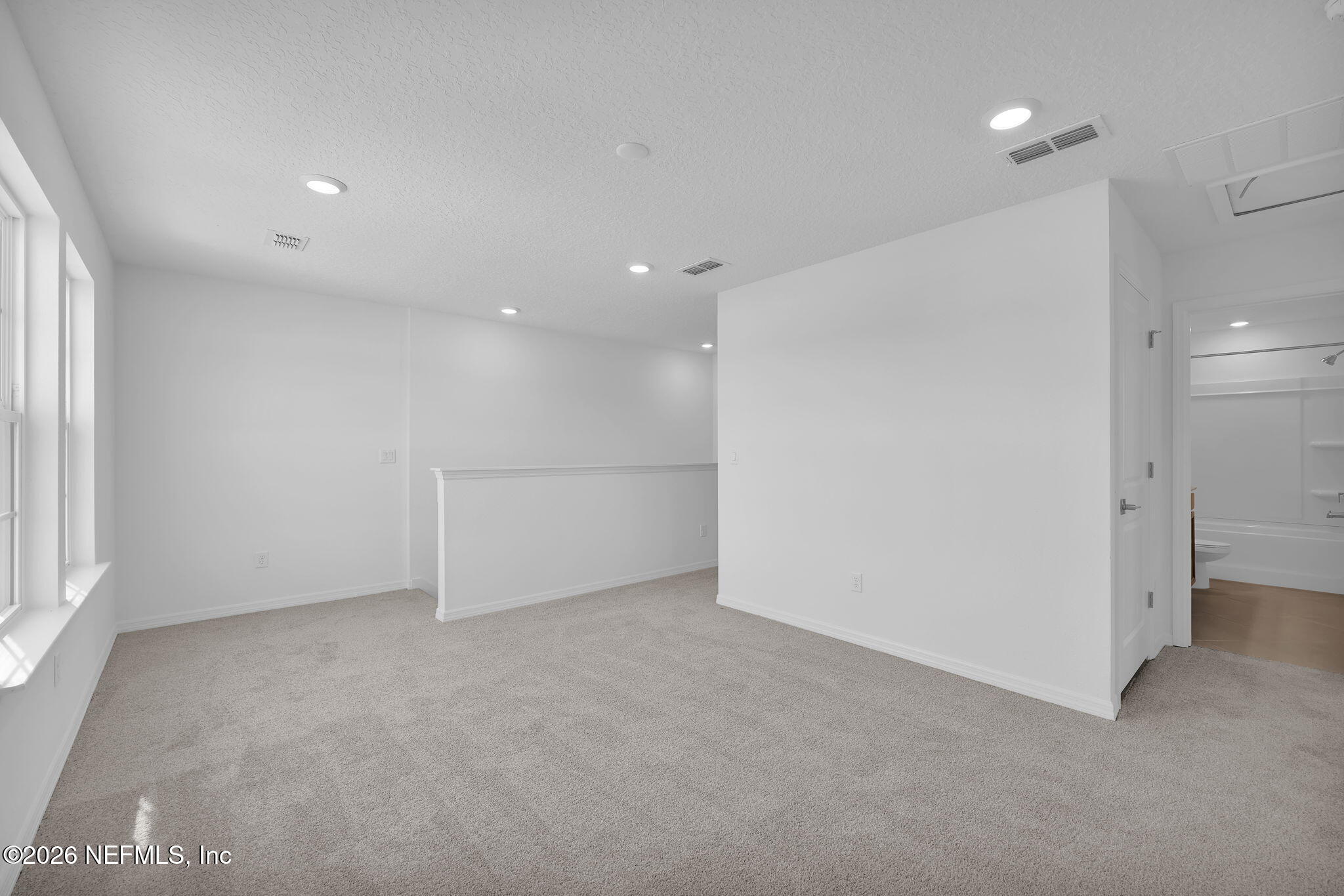 1706 Mickey Way Middleburg, FL 32068 - Photo 26 of 27 wooden floor in an empty room with a kitchen