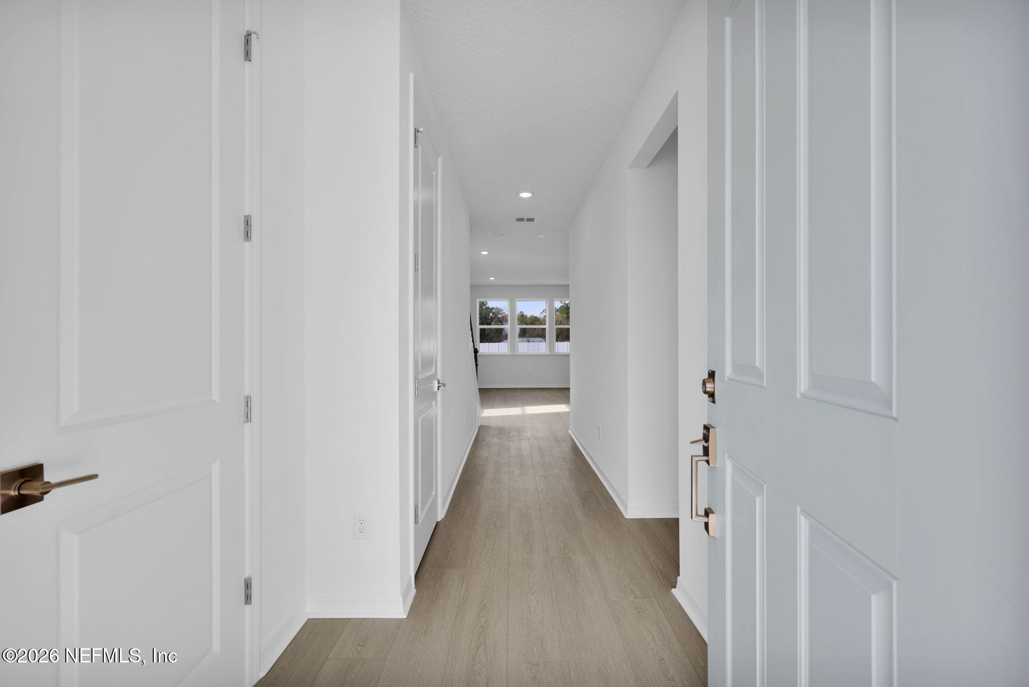 1706 Mickey Way Middleburg, FL 32068 - Photo 6 of 27 a view of a hallway with wooden floor and staircase
