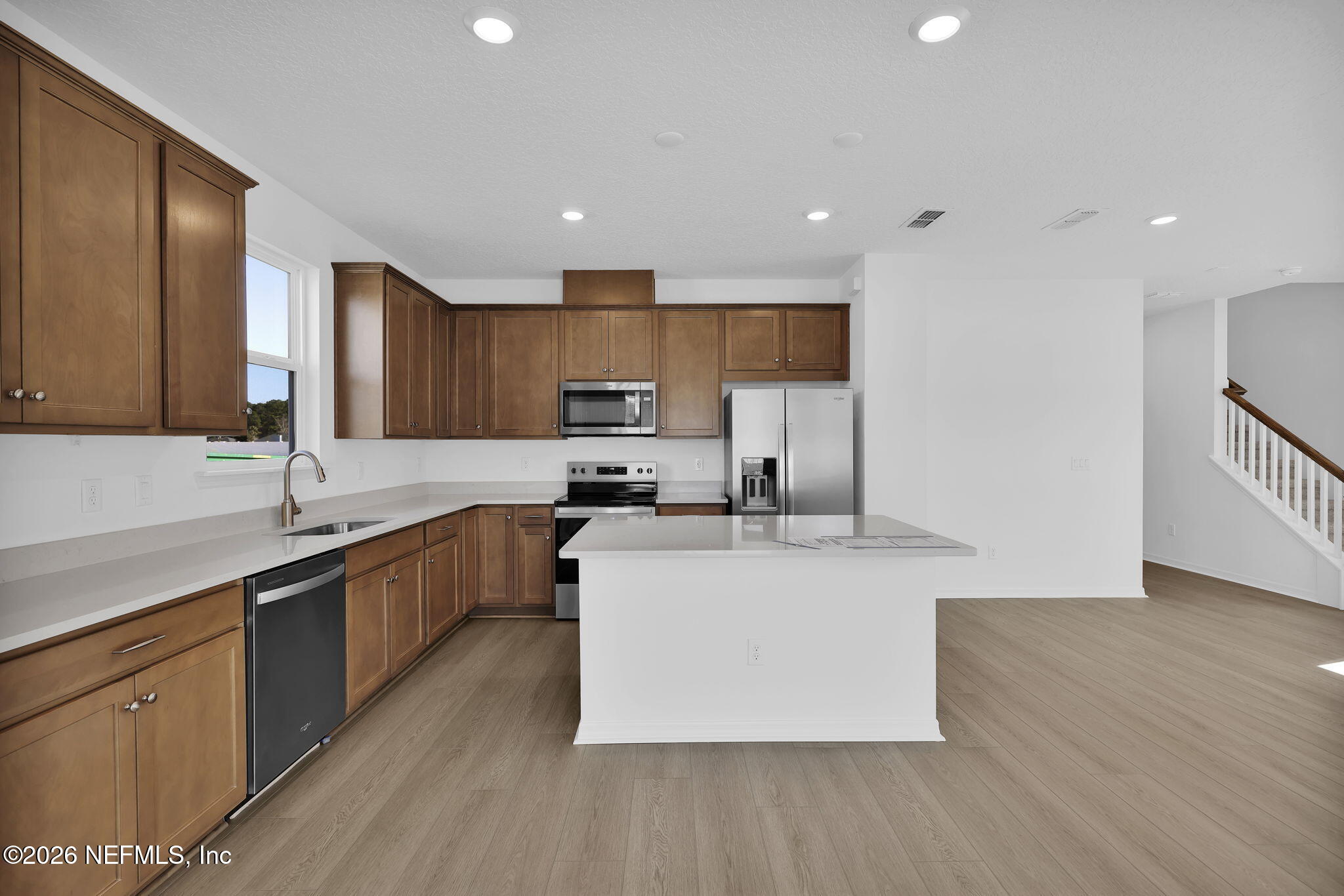 1706 Mickey Way Middleburg, FL 32068 - Photo 8 of 27 a kitchen with stainless steel appliances granite countertop a sink a stove a refrigerator and cabinets