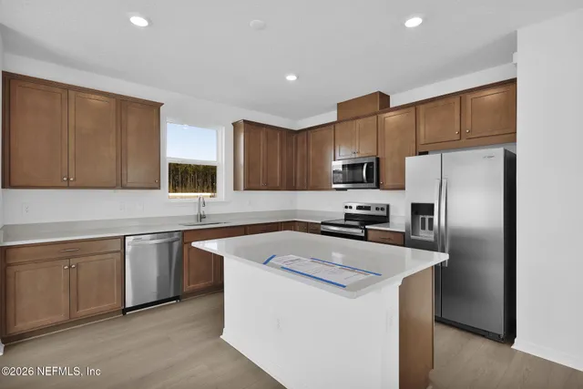 a kitchen with a sink stove top oven and cabinets