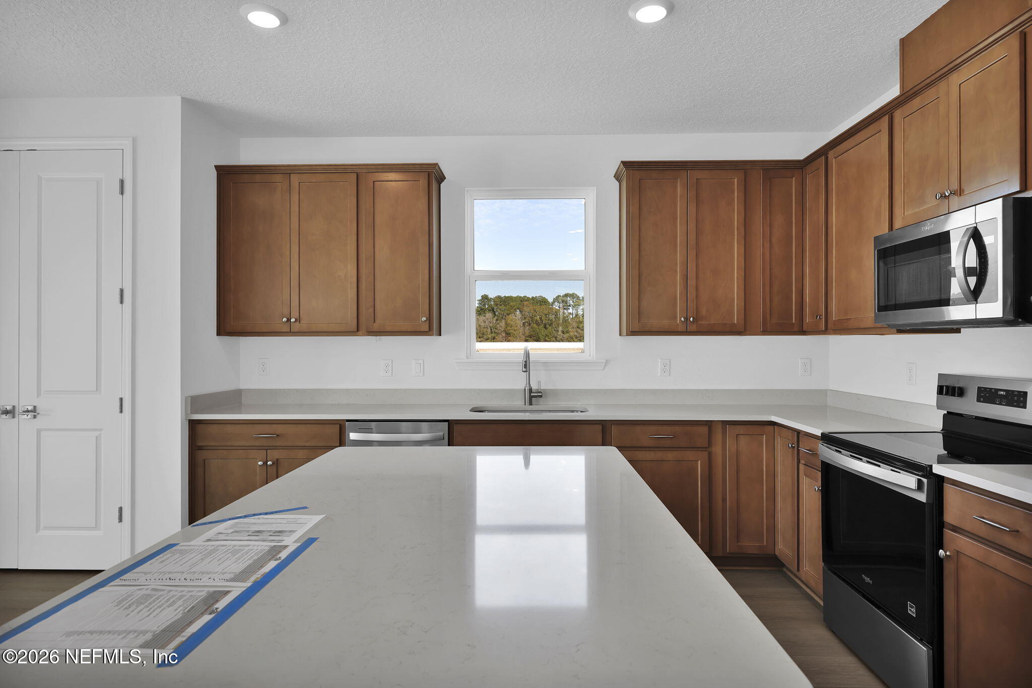 1706 Mickey Way Middleburg, FL 32068 - Photo 10 of 27 a kitchen with a sink stove top oven and cabinets