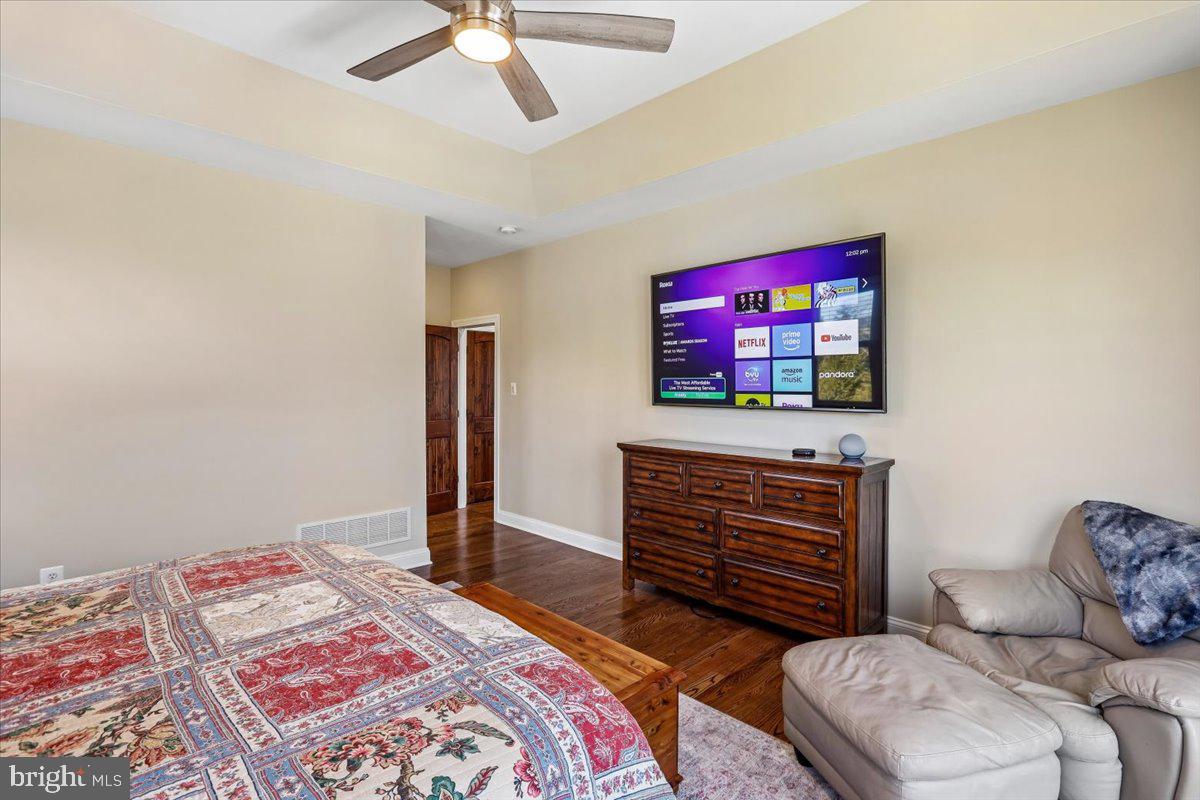 496 Leisters Church Road Westminster, MD 21157 - Photo 33 of 118 a bedroom with a bed and a flat screen tv
