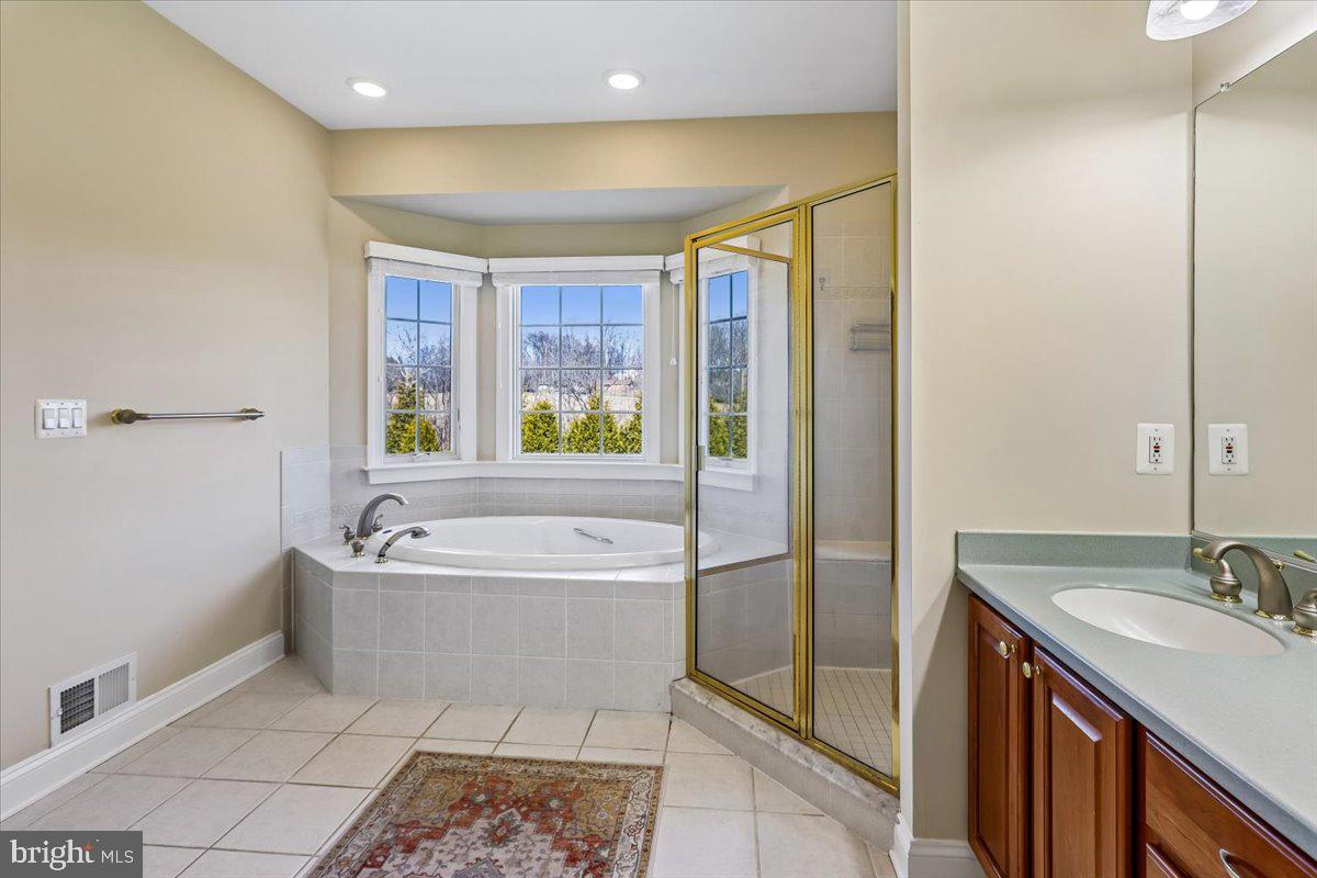 496 Leisters Church Road Westminster, MD 21157 - Photo 35 of 118 a spacious bathroom with a tub sink and mirror