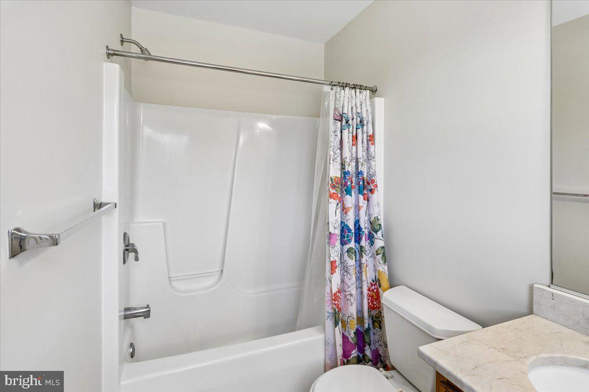 496 Leisters Church Road Westminster, MD 21157 - Photo 50 of 118 a bathroom with a shower curtain and a toilet