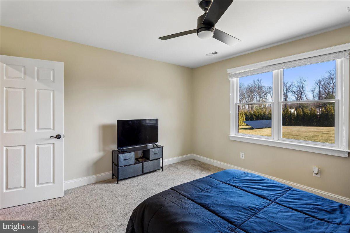 496 Leisters Church Road Westminster, MD 21157 - Photo 51 of 118 a bedroom with a bed and a flat tv screen on dresser