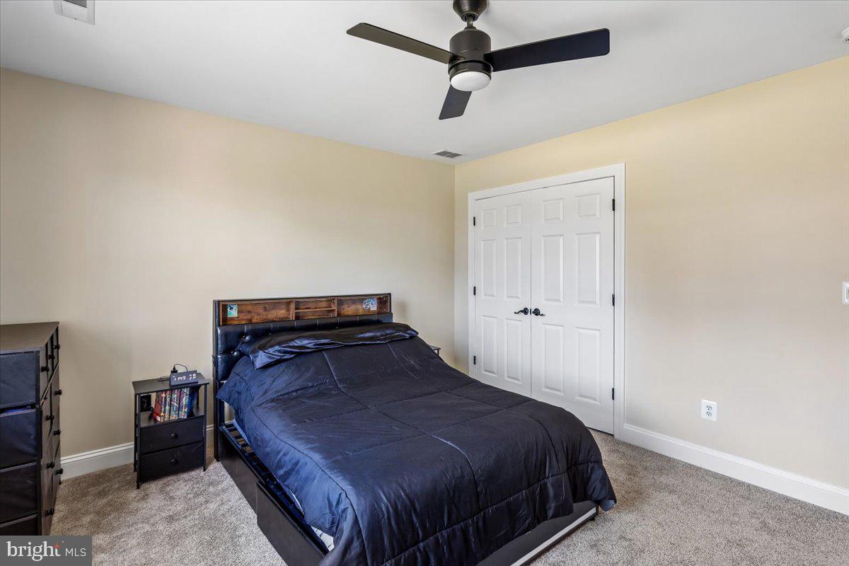 496 Leisters Church Road Westminster, MD 21157 - Photo 52 of 118 a bedroom with a bed and a ceiling fan