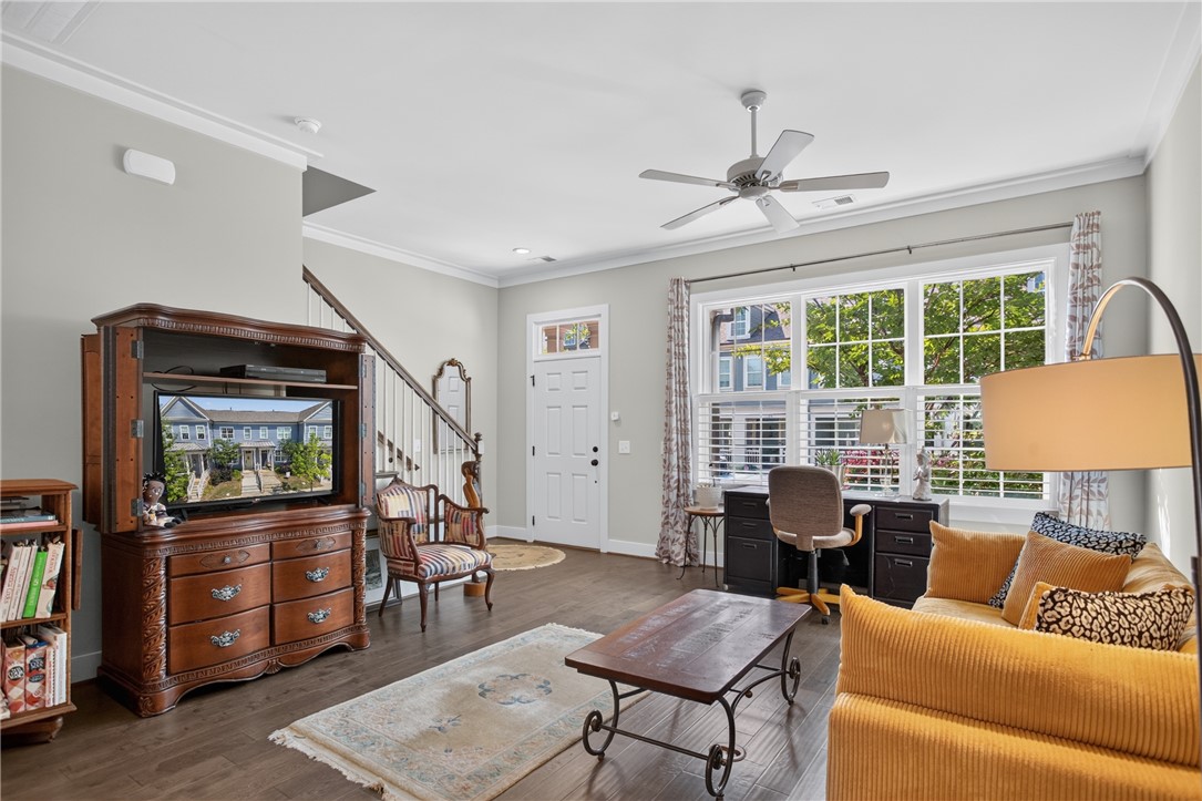 112 Tuttle Street Clemson, SC 29631 - Photo 10 of 46 Hardwood floors and crown molding elevate this open-concept living space, featuring an inviting entrance and abundant natural light.