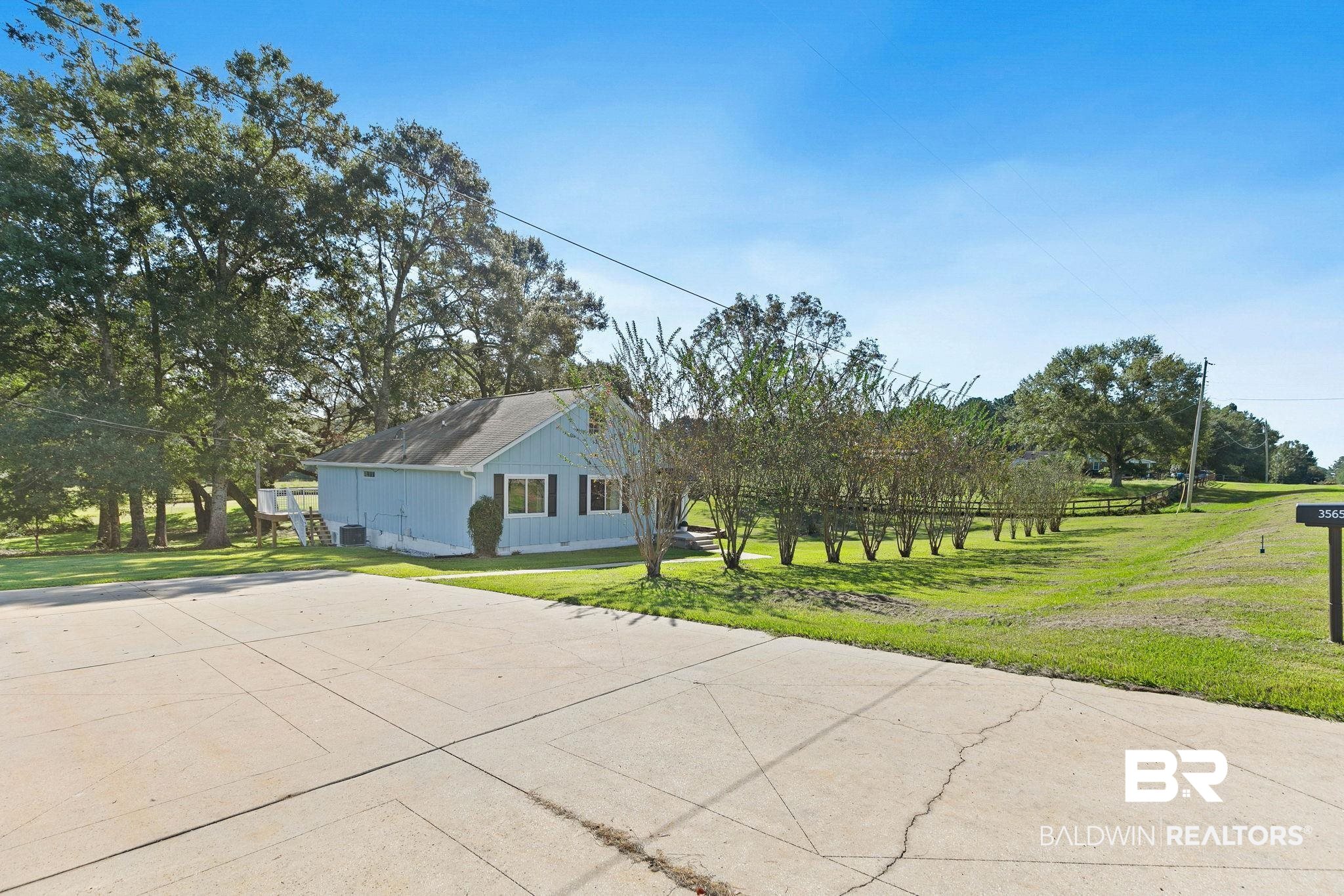 35650 Spring Road North Stapleton, AL 36578 - Photo 6 of 70 View of property exterior featuring a yard and concrete driveway