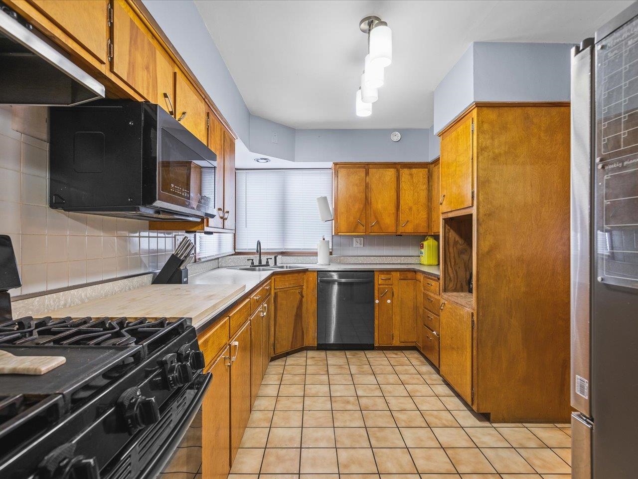 3215 Rural Street Rockford, IL 61107 - Photo 12 of 25 a kitchen with a sink a stove and refrigerator
