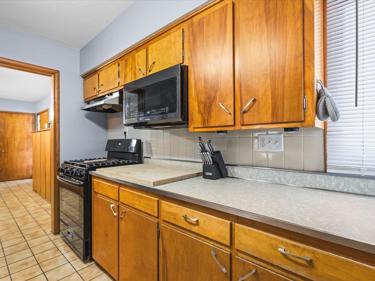 3215 Rural Street Rockford, IL 61107 - Photo 13 of 25 a kitchen with stainless steel appliances granite countertop a sink a stove and cabinets