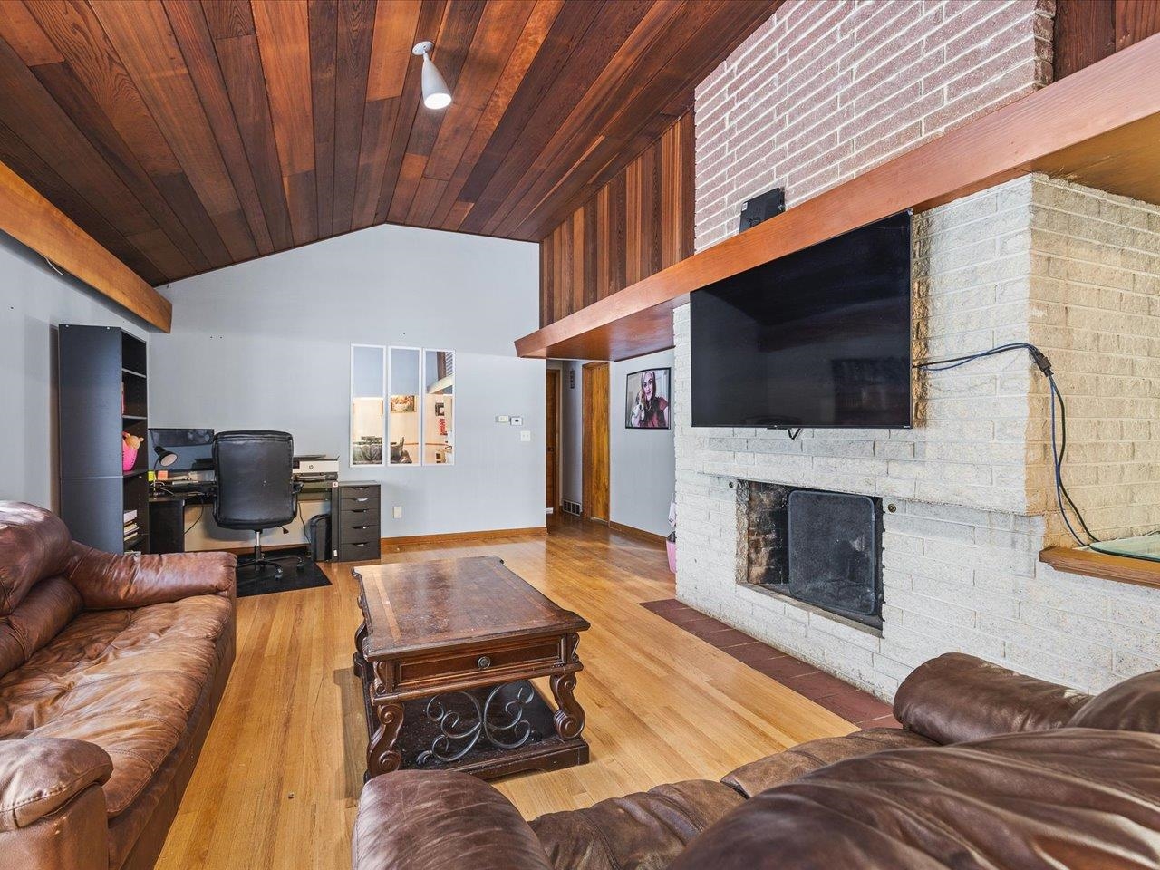 3215 Rural Street Rockford, IL 61107 - Photo 9 of 25 a living room with furniture a flat screen tv and a fireplace