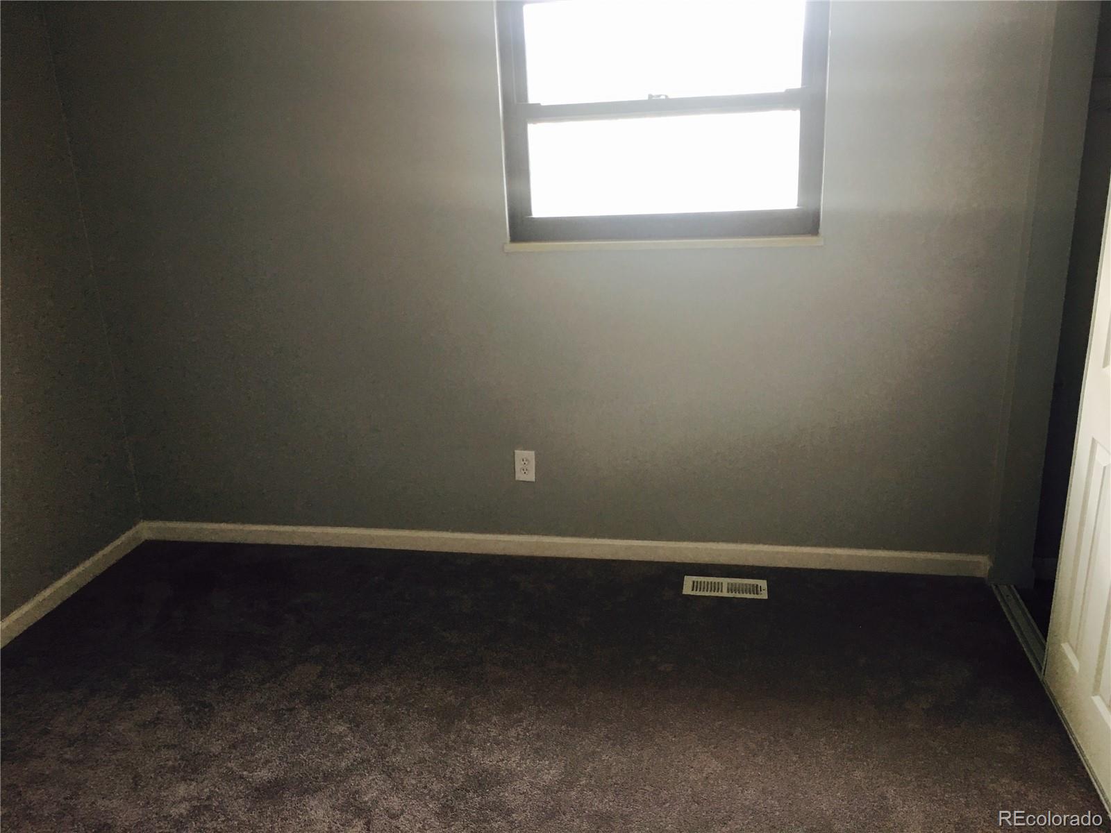 5542 Scranton Street Denver, CO 80239 - Photo 15 of 16 an empty room with a window