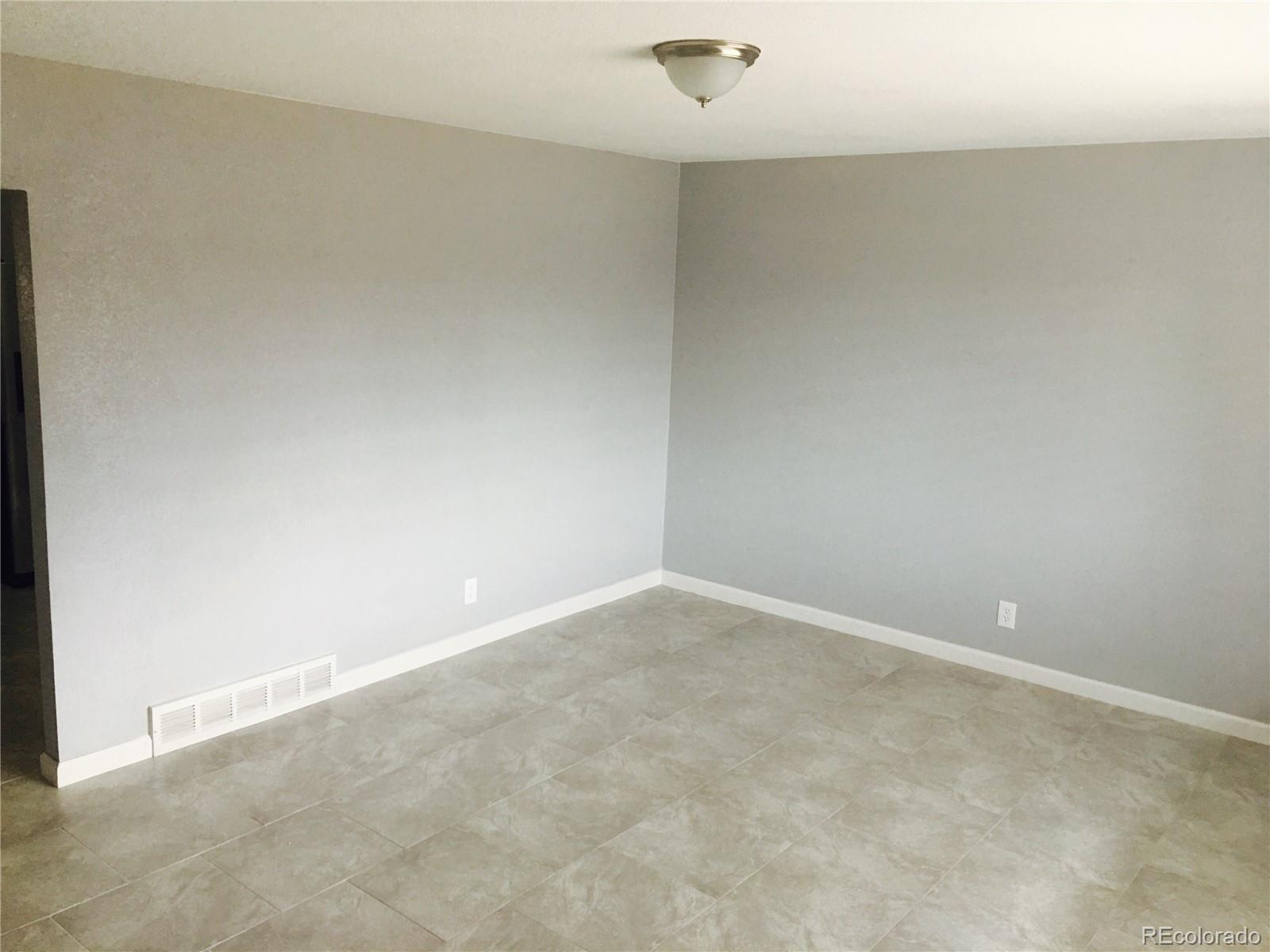 5542 Scranton Street Denver, CO 80239 - Photo 3 of 16 a view of an empty room