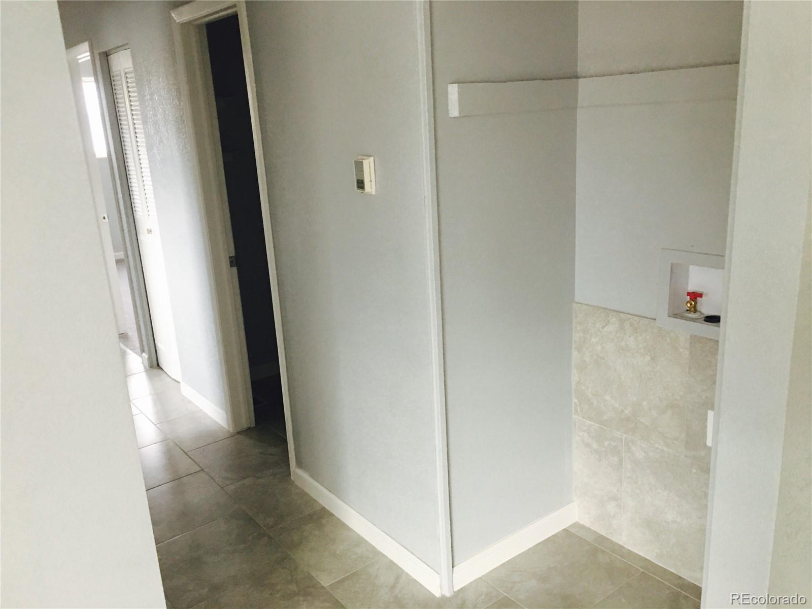 5542 Scranton Street Denver, CO 80239 - Photo 5 of 16 a view of a hallway