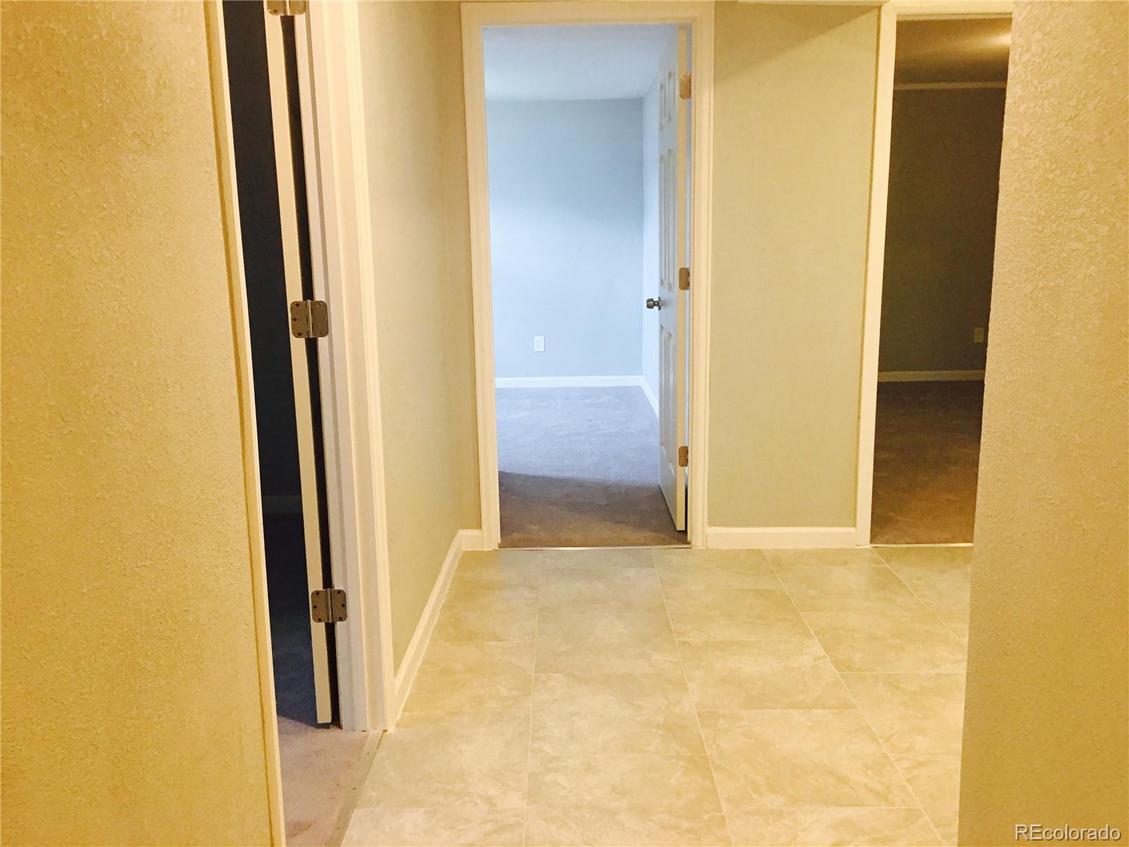 5542 Scranton Street Denver, CO 80239 - Photo 7 of 16 a view of an empty room