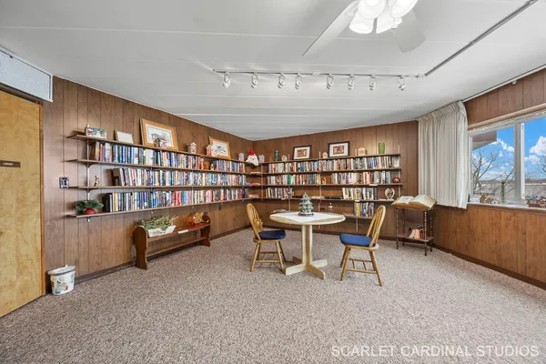 a view of a livingroom with furniture and a bookshelf