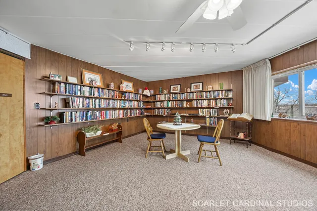 a view of a livingroom with furniture and a bookshelf