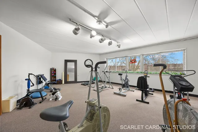 a room with gym equipment and windows