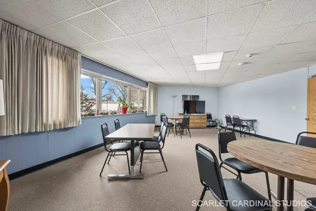 a living room with furniture a flat screen tv and a large window