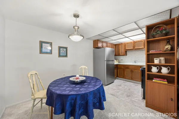 a kitchen with stainless steel appliances kitchen island a table and chairs