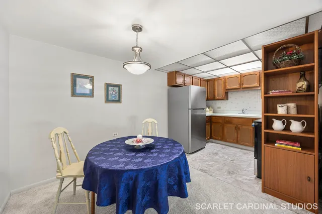 a kitchen with stainless steel appliances kitchen island a table and chairs