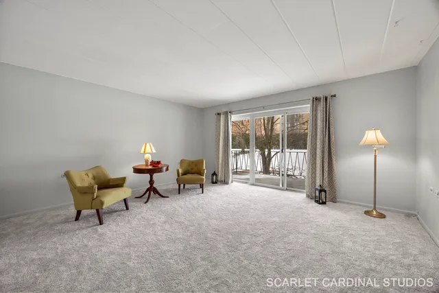 a living room with furniture and a floor to ceiling window