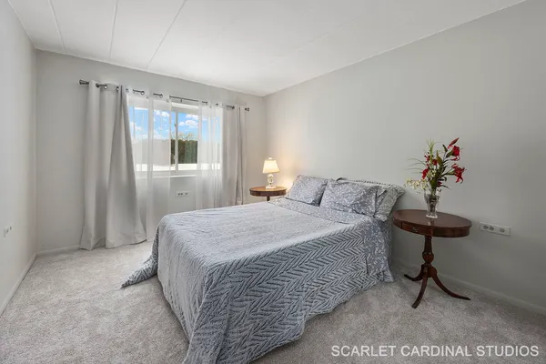 a bedroom with a bed and a table