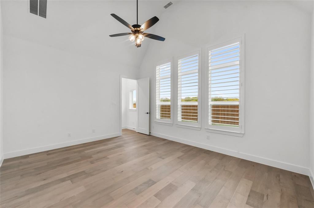 15577 Desert Broom Road Frisco, TX 75035 - Photo 14 of 37 an empty room with wooden floor and windows