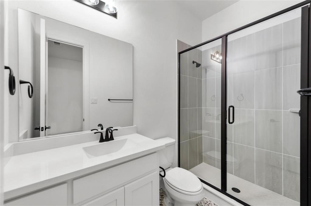 15577 Desert Broom Road Frisco, TX 75035 - Photo 17 of 37 a bathroom with a sink toilet and shower
