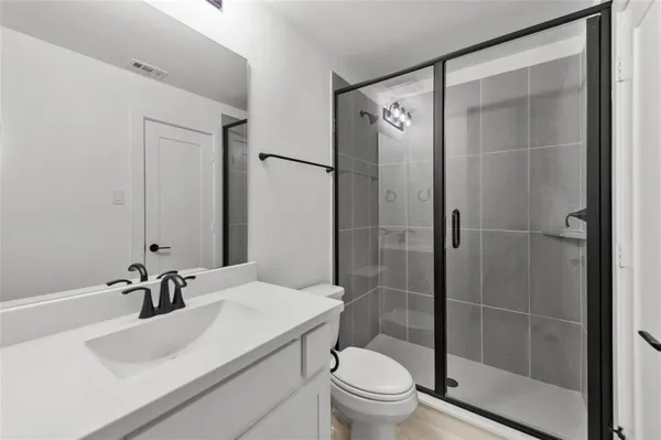 a bathroom with a sink toilet and shower