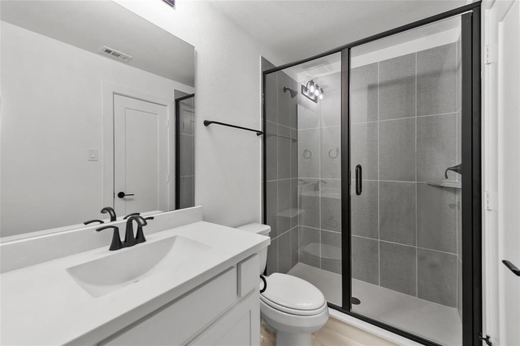 15577 Desert Broom Road Frisco, TX 75035 - Photo 23 of 37 a bathroom with a sink toilet and shower