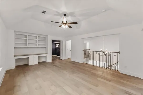 a view of a livingroom with a furniture and chandelier fan