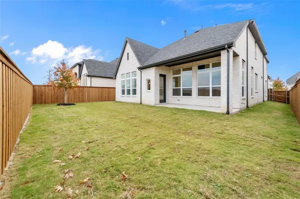 a view of a house with a yard and sitting area