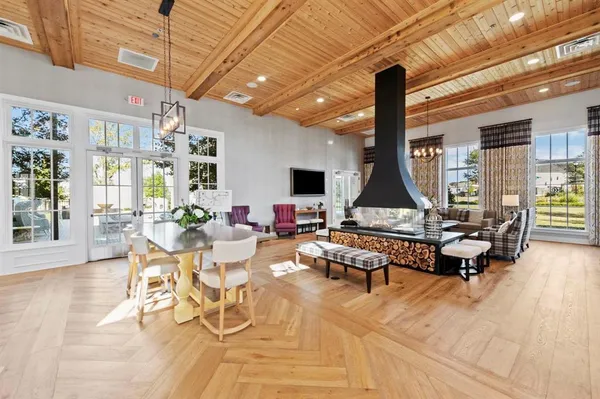a living room with patio furniture and a flat screen tv
