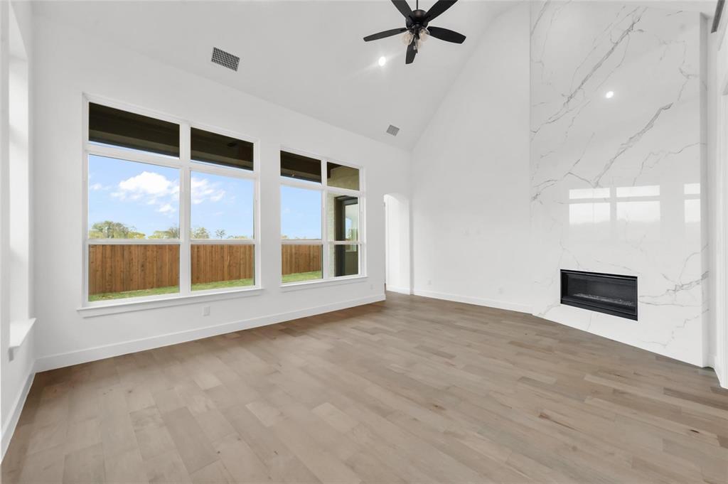 15577 Desert Broom Road Frisco, TX 75035 - Photo 10 of 37 a view of an empty room with a window and wooden floor