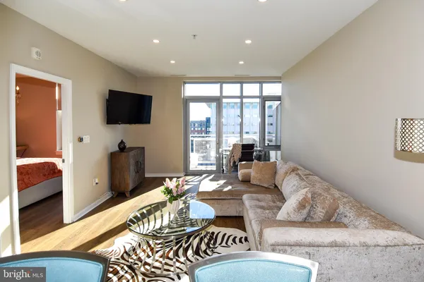 a living room with furniture and a dining table