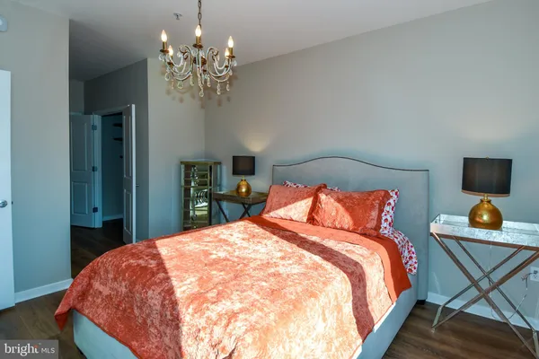 a bedroom with a bed window and table