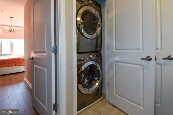 a bathroom with a granite countertop toilet sink and mirror