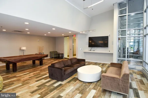 a living room with furniture and a floor to ceiling window