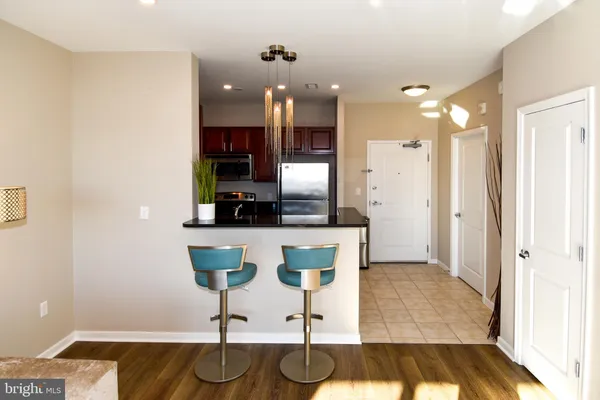 a kitchen with stainless steel appliances granite countertop a refrigerator a stove and a sink