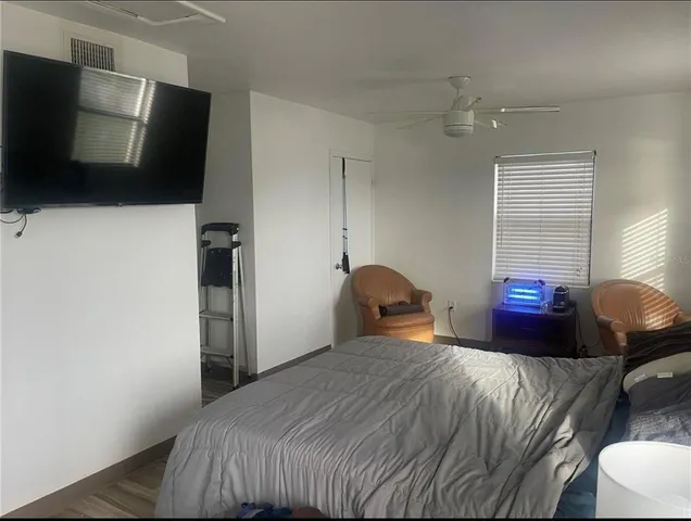 a bedroom with a bed and flat screen tv