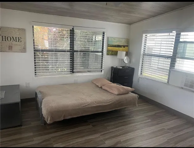 a bedroom with a bed couch and window