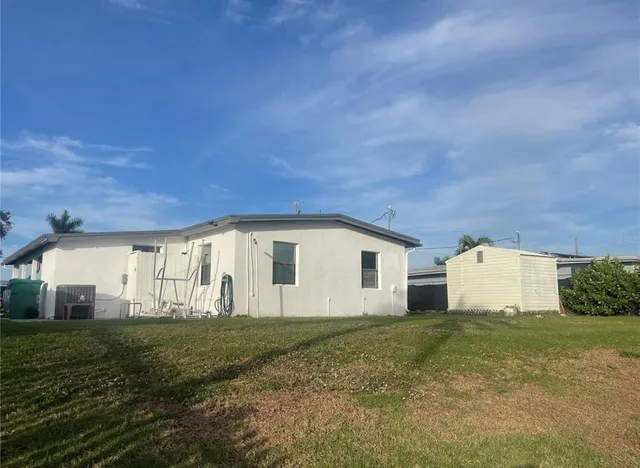 a view of a house with a backyard