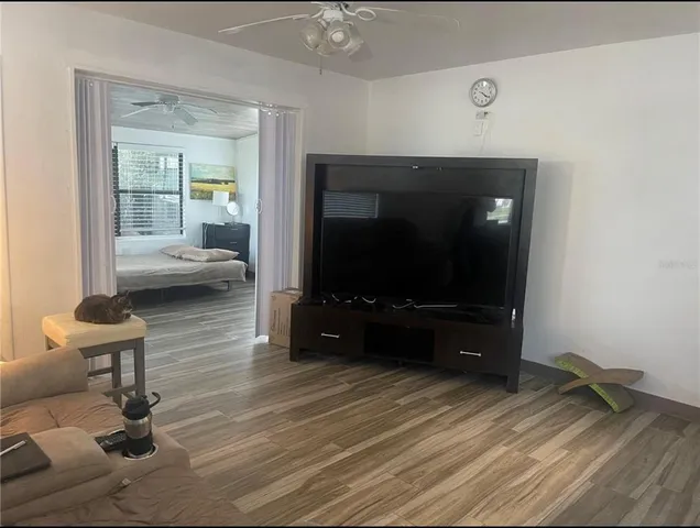 a living room with furniture and wooden floor